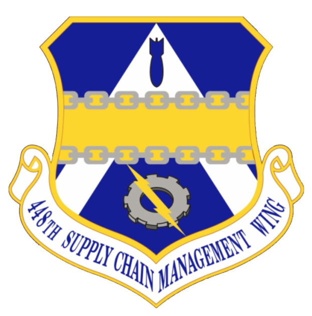 Logo des 48. Versorgungsgeschwader mit einem blauen Schild mit einem weißen Stern und einem weißen Banner mit der Aufschrift "Versorgungsgeschwader" in blau, alles von einem weißen Rand umgeben, mit der schwarzen Schrift "48. Versorgungsgeschwader" in fetter Schrift.