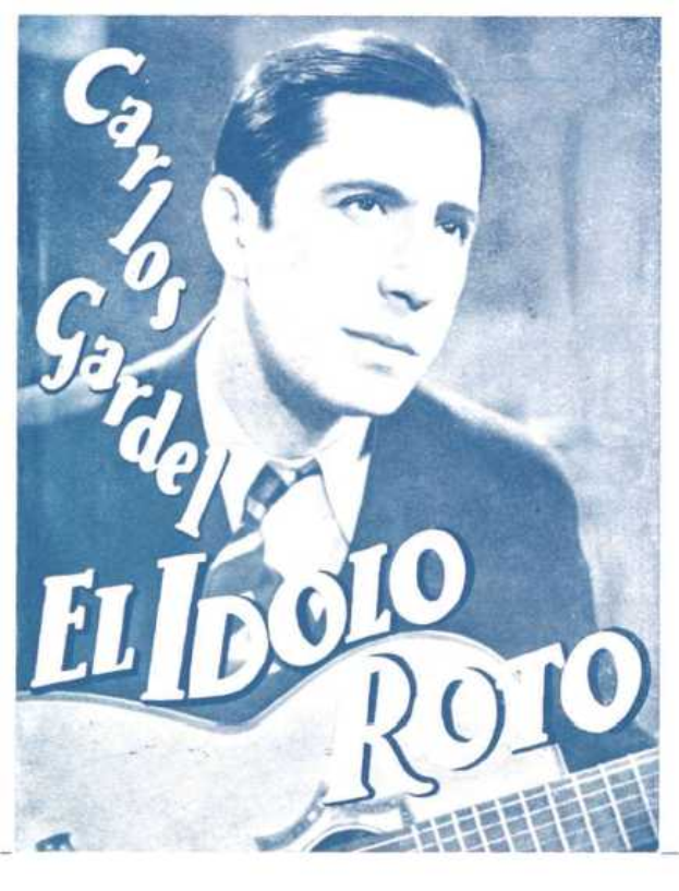 Plakat von El Idolo Roro, einem spanischen S├Ąnger-Schreiber, der eine Gitarre h├Ąlt, ein wei├čes Hemd und einen schwarzen Anzug tr├Ągt, mit zur├╝ckgek├Ąmmtem Haar und einem ernsten Ausdruck, vor einem hellblauen Hintergrund mit fetter schwarzer Schrift.
